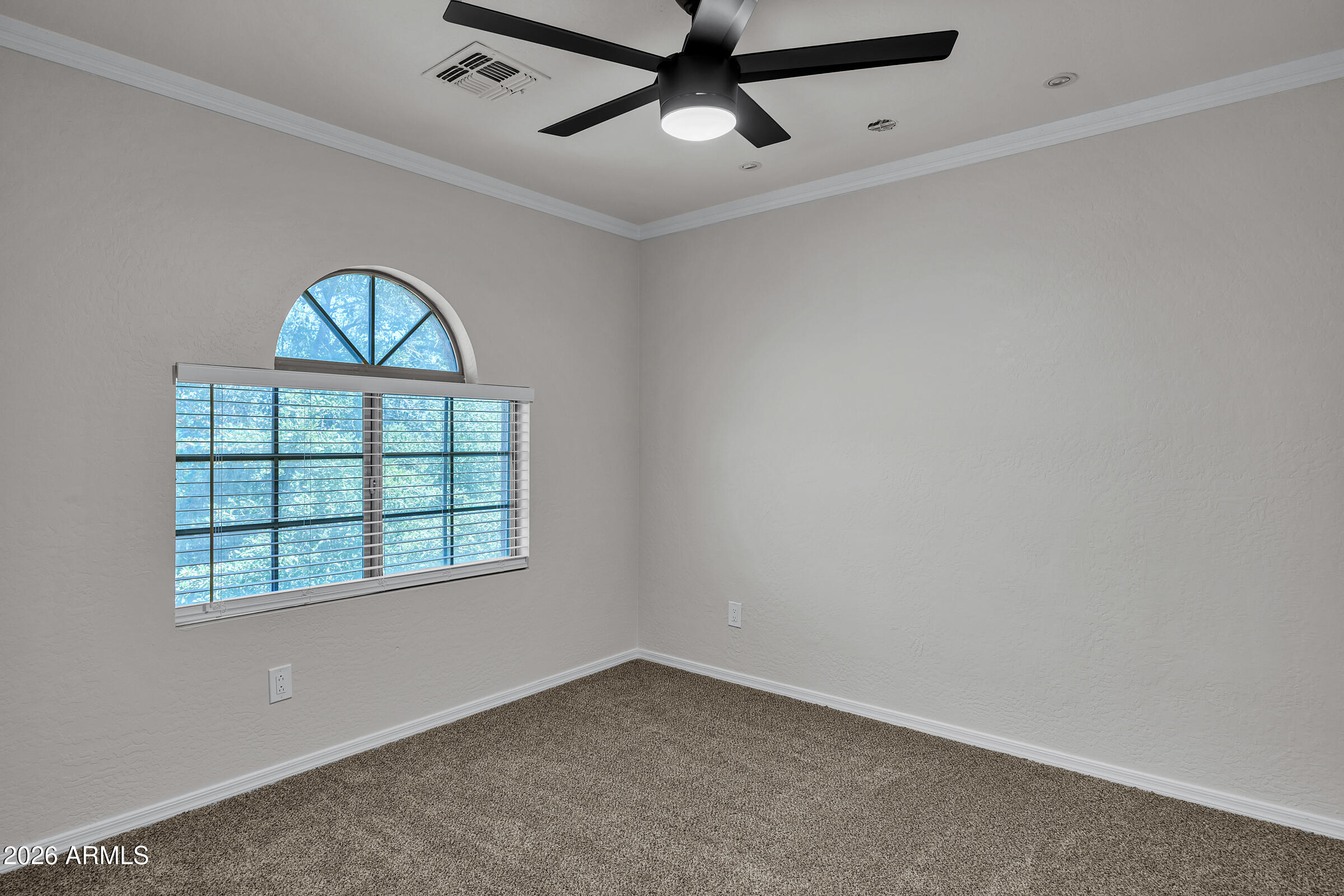 5725 East Good Pasture Lane Florence, AZ 85132 - Photo 25 of 40 an empty room with windows and ceiling fan