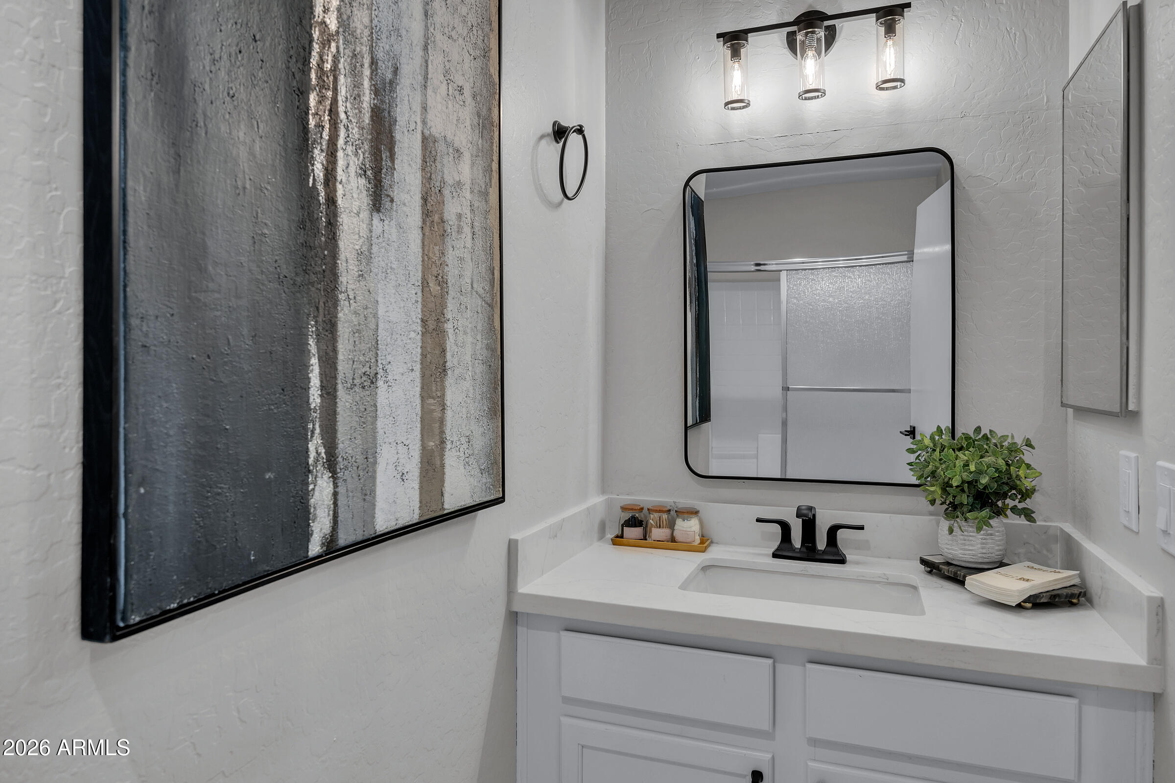 5725 East Good Pasture Lane Florence, AZ 85132 - Photo 26 of 40 a bathroom with a sink a mirror and vanity