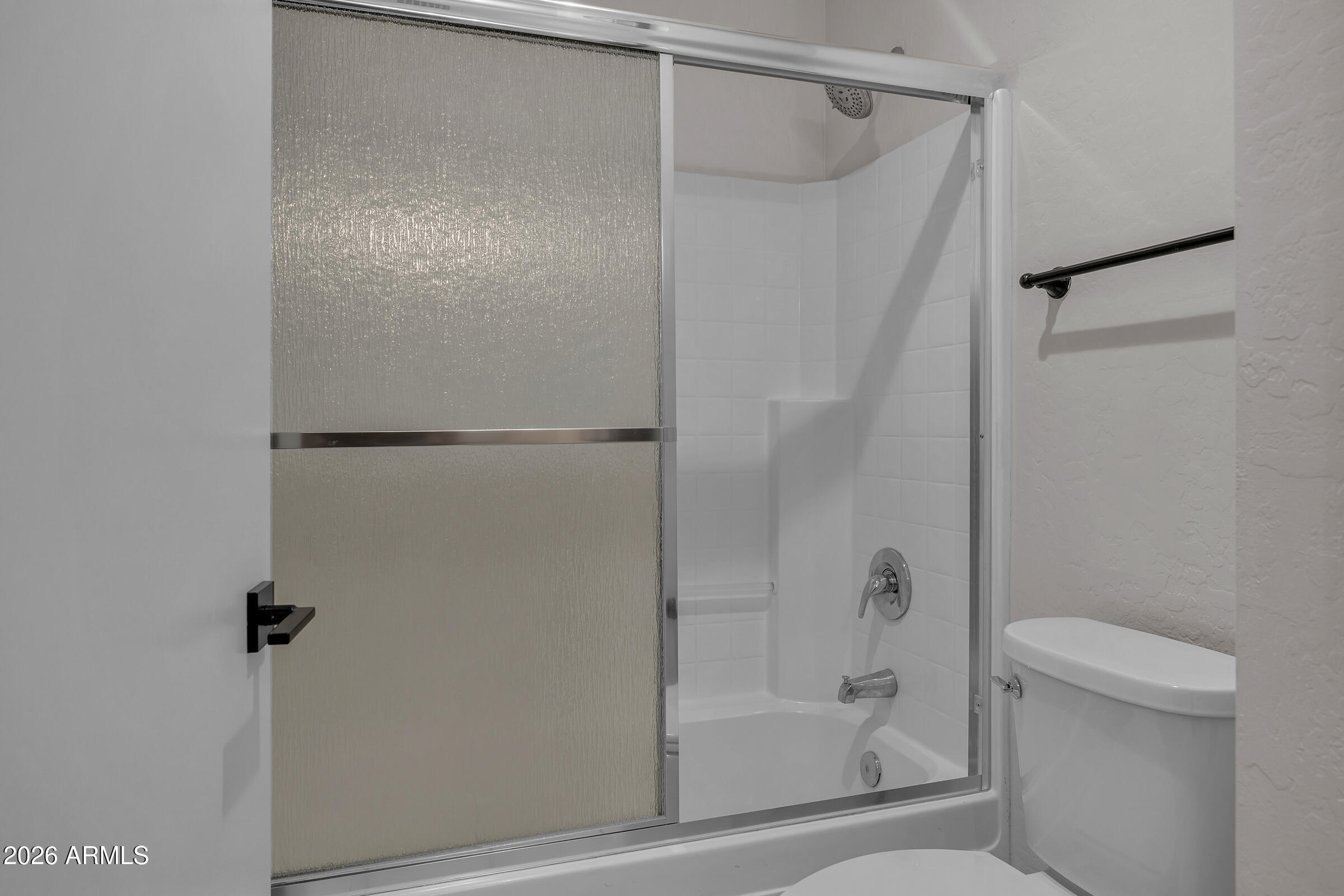 5725 East Good Pasture Lane Florence, AZ 85132 - Photo 27 of 40 a bathroom with a glass shower door