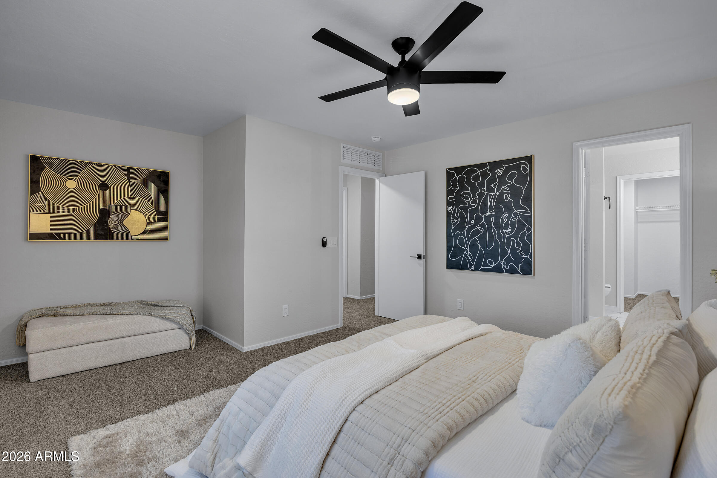 5725 East Good Pasture Lane Florence, AZ 85132 - Photo 29 of 40 a bedroom with a large bed and a painting on the wall