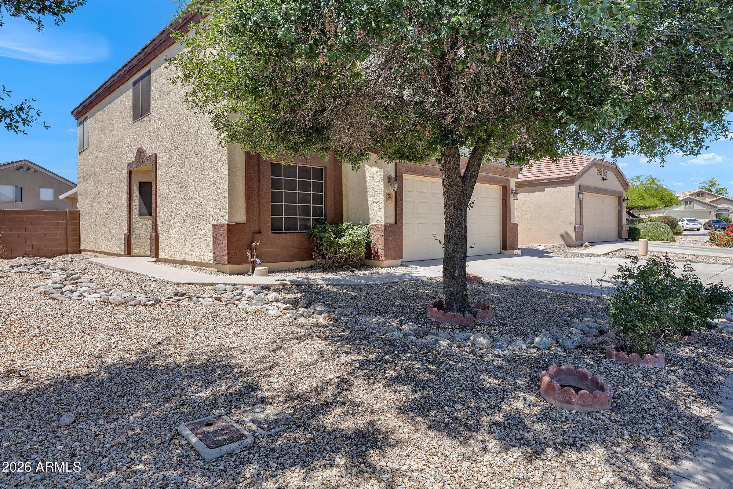 5725 East Good Pasture Lane Florence, AZ 85132 - Photo 3 of 40 a front view of a house with garden