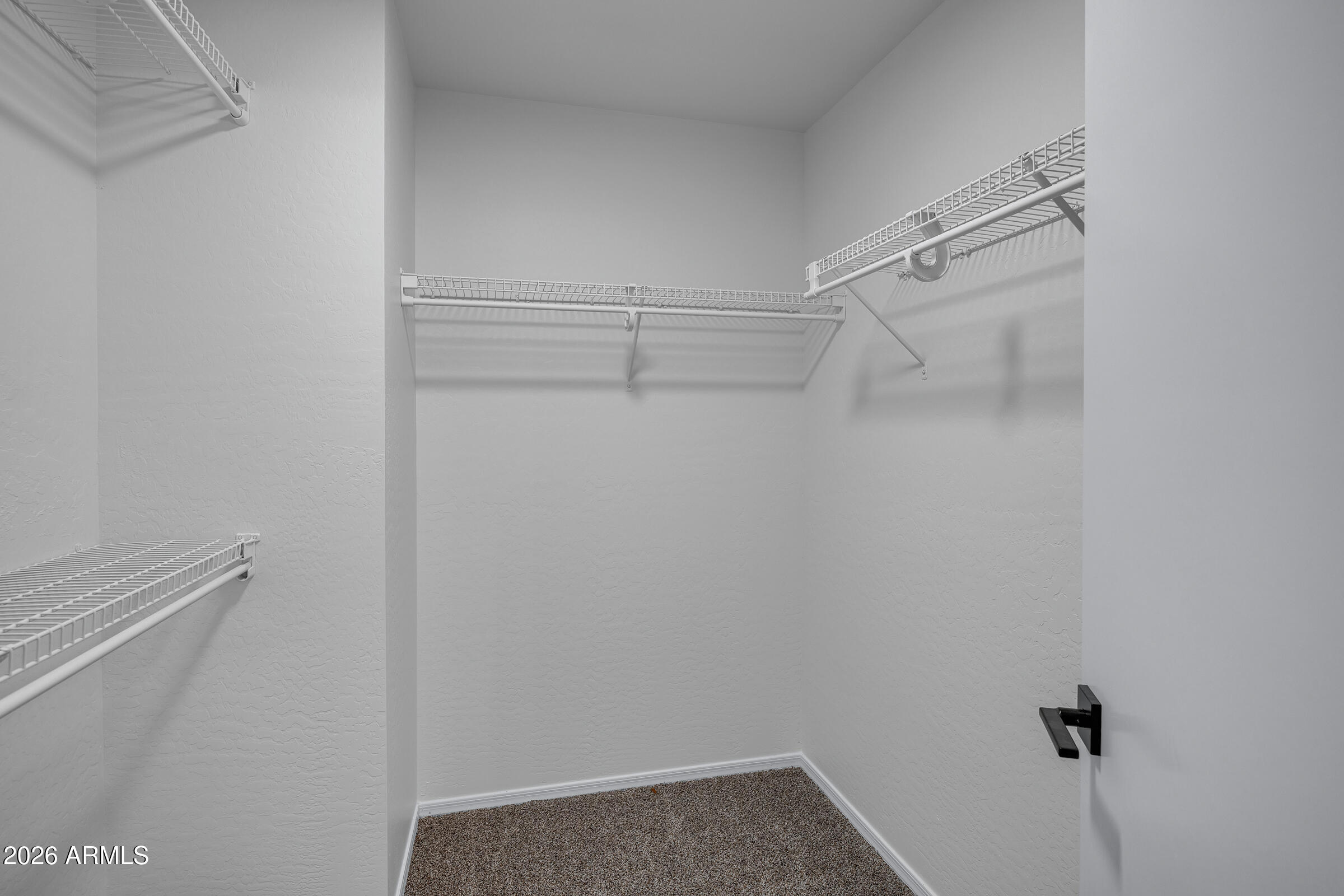 5725 East Good Pasture Lane Florence, AZ 85132 - Photo 32 of 40 a view of a room with racks on the wall