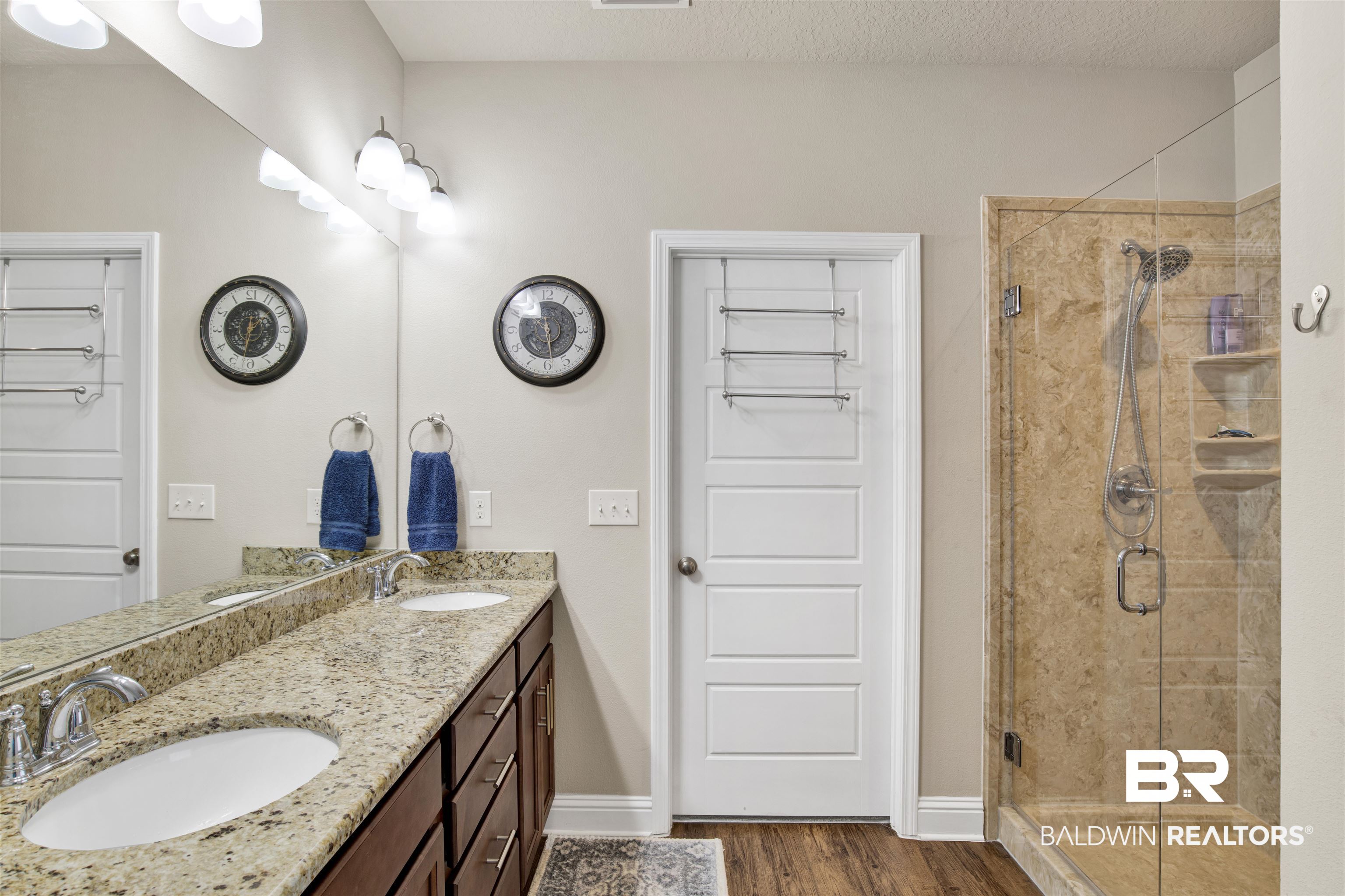 278 Silo Loop Fairhope, AL 36532 - Photo 11 of 26 Bathroom featuring a shower stall, double vanity, wood finished floors, and a textured ceiling
