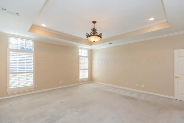 an empty room that has a window and a ceiling fan