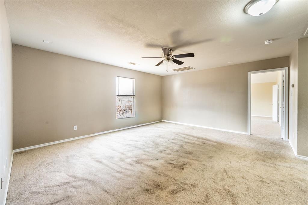 1101 Halifax Lane Forney, TX 75126 - Photo 17 of 32 a view of an empty room with a ceiling fan
