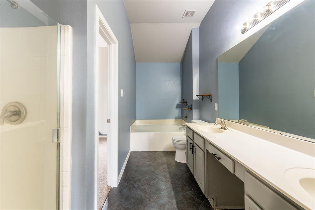 1101 Halifax Lane Forney, TX 75126 - Photo 21 of 32 a bathroom with a double vanity sink a toilet and a large mirror