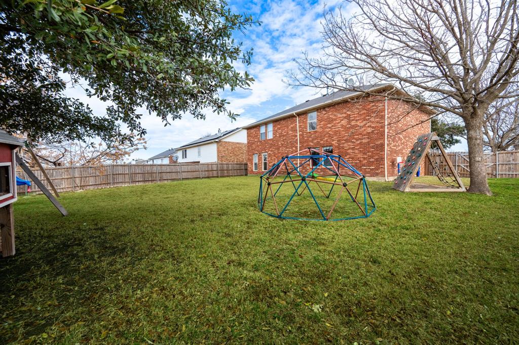 1101 Halifax Lane Forney, TX 75126 - Photo 31 of 32 a house view with a play ground in front of it