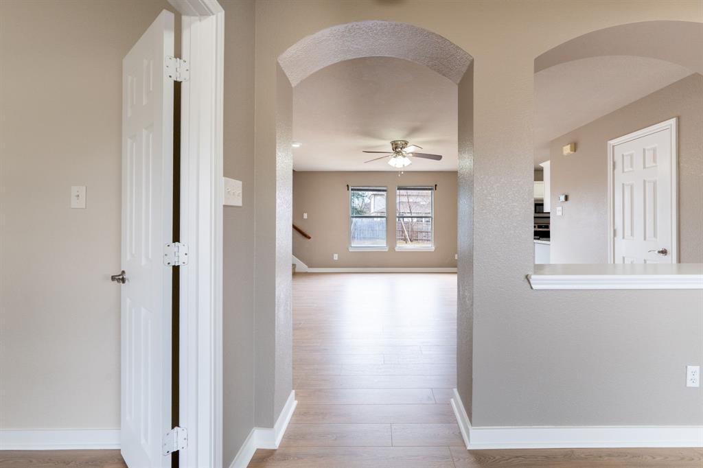 1101 Halifax Lane Forney, TX 75126 - Photo 5 of 32 a view of an empty room with wooden floor and a window