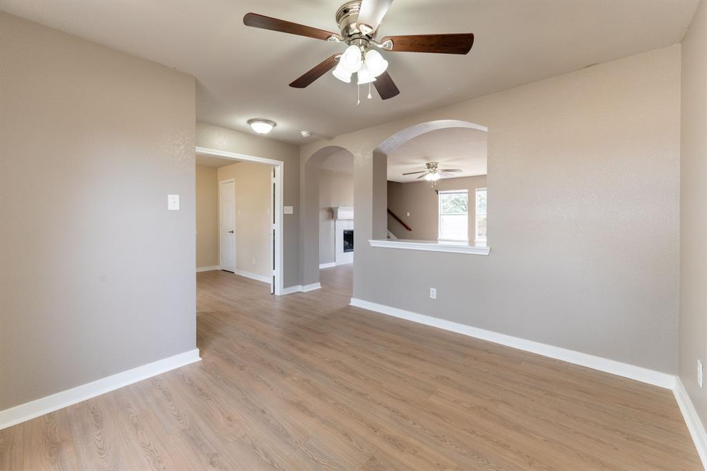 1101 Halifax Lane Forney, TX 75126 - Photo 7 of 32 wooden floor in an empty room with a window