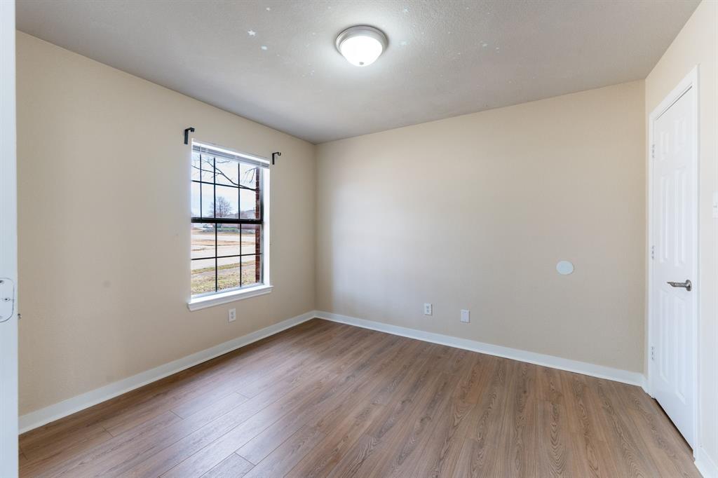 1101 Halifax Lane Forney, TX 75126 - Photo 8 of 32 an empty room with wooden floor and windows
