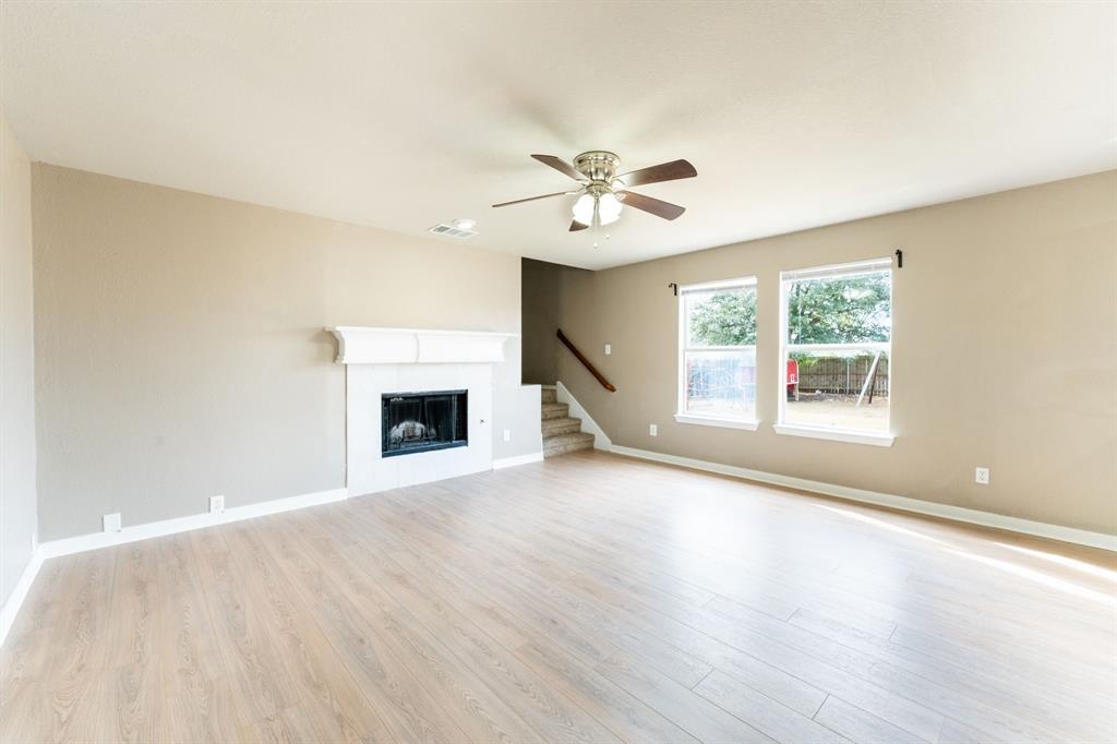 1101 Halifax Lane Forney, TX 75126 - Photo 10 of 32 a view of an empty room with a window and fireplace
