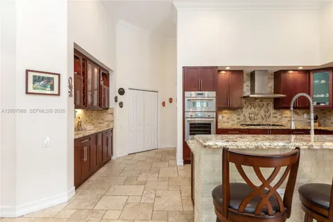 a kitchen with granite countertop a refrigerator and a sink