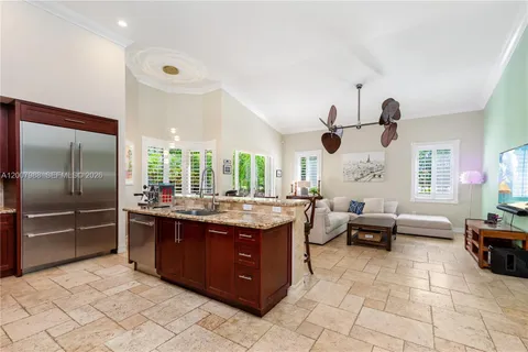 a kitchen with stainless steel appliances granite countertop a stove refrigerator and cabinets