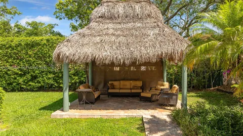 an aerial view of a house with yard swimming pool and outdoor seating