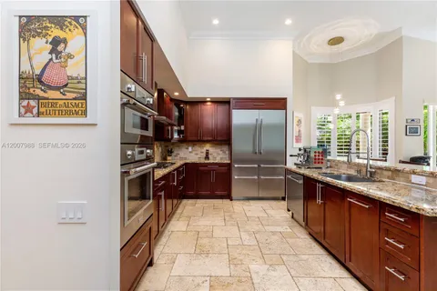 a kitchen with stainless steel appliances granite countertop a sink and stove