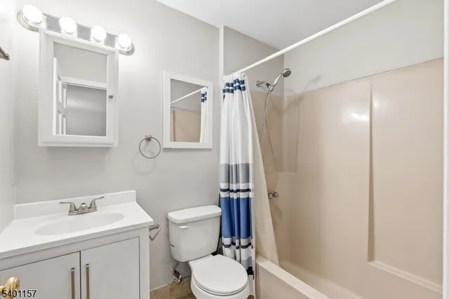 a white toilet sitting next to a bathroom sink