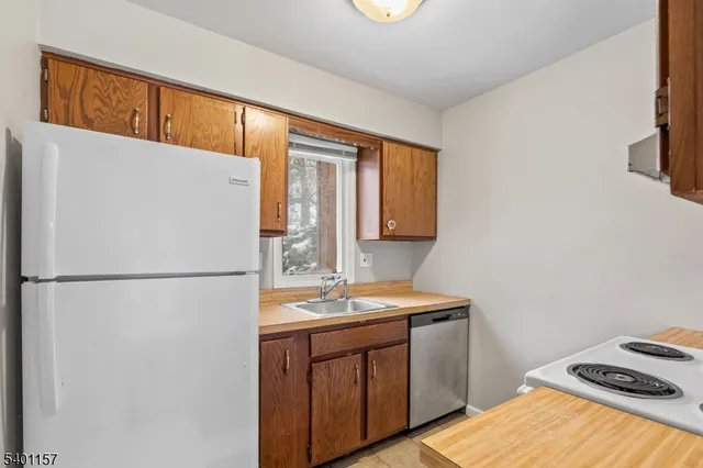 a white refrigerator freezer sitting inside of a kitchen
