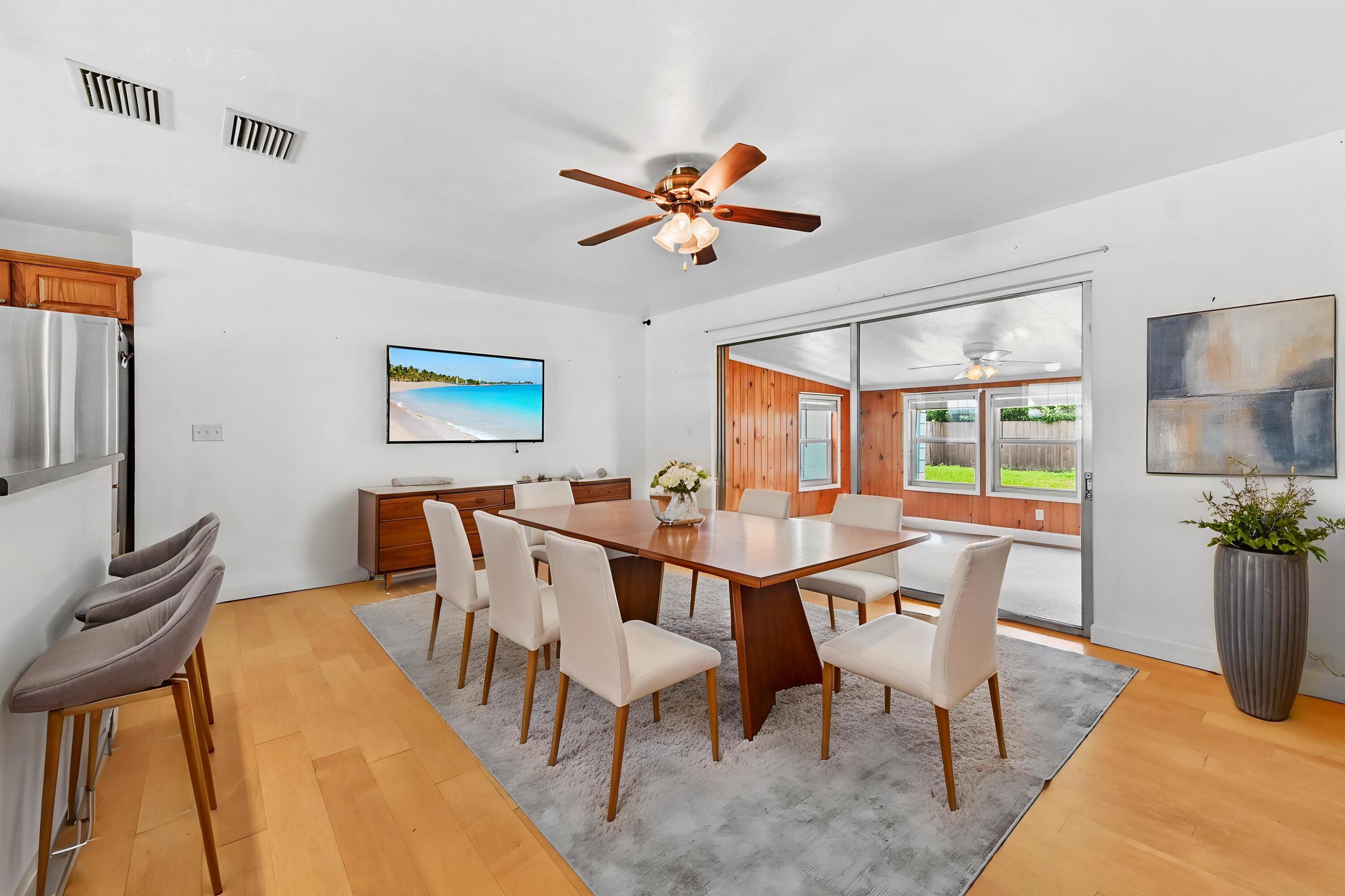5709 Southeast Indigo Avenue Stuart, FL 34997 - Photo 7 of 26 a view of a dining room with furniture window and outside view