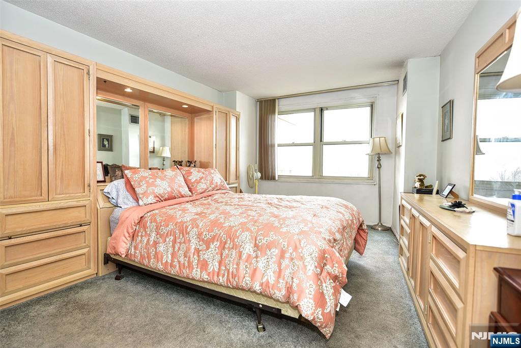 555 North, Unit 8N Fort Lee, NJ 07024 - Photo 14 of 19 a bedroom with a bed and a window