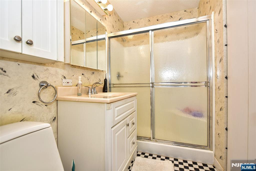 555 North, Unit 8N Fort Lee, NJ 07024 - Photo 15 of 19 a bathroom with a sink and a mirror