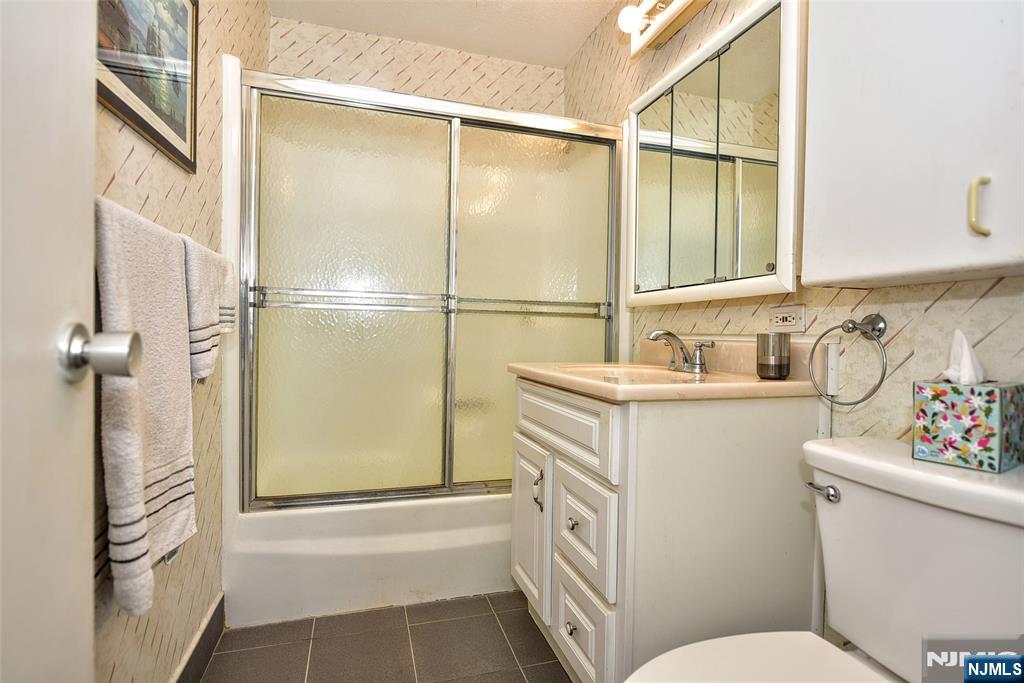 555 North, Unit 8N Fort Lee, NJ 07024 - Photo 17 of 19 a bathroom with a sink toilet and shower