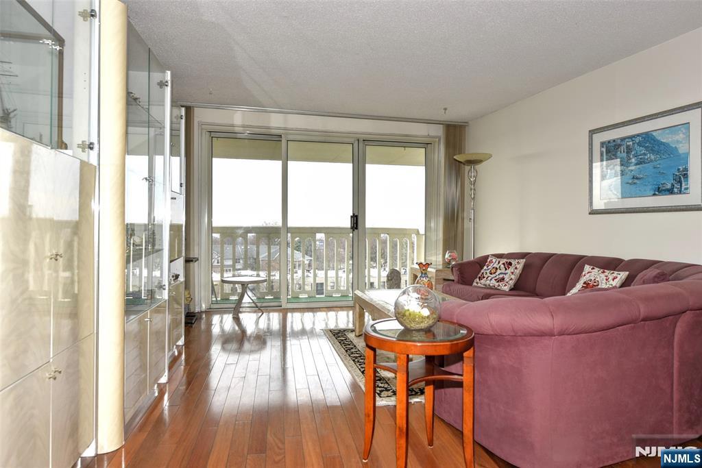 555 North, Unit 8N Fort Lee, NJ 07024 - Photo 8 of 19 a living room with furniture and a large window