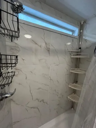 a kitchen with granite countertop white cabinets and stainless steel appliances