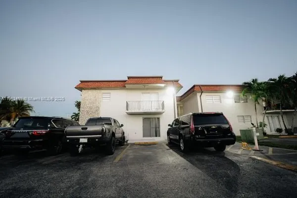 a living room with furniture a fireplace and a potted plant