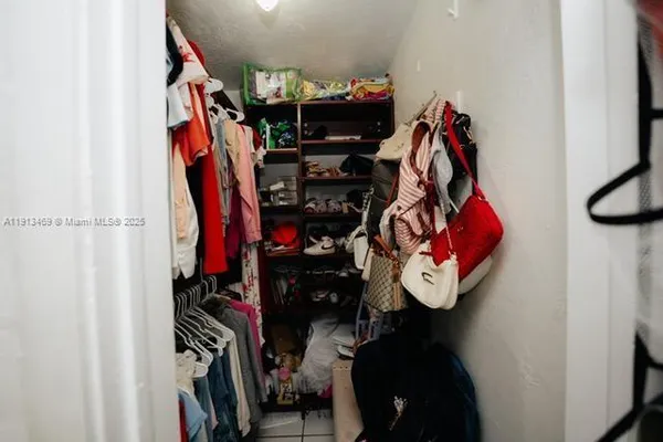 a room with a refrigerator and cabinets