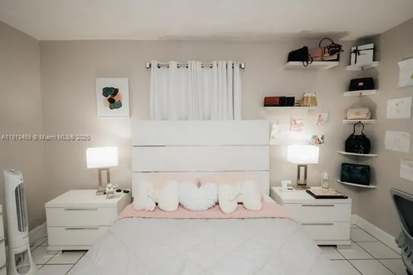 a spacious bedroom with a bed and a window