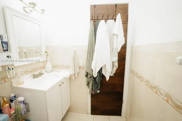 a white toilet sitting next to a bathroom sink