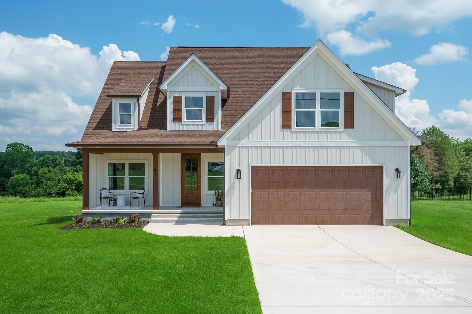 181 Lone Pine Road Statesville, NC 28625 - Photo 2 of 42 a front view of a house with a yard and garage