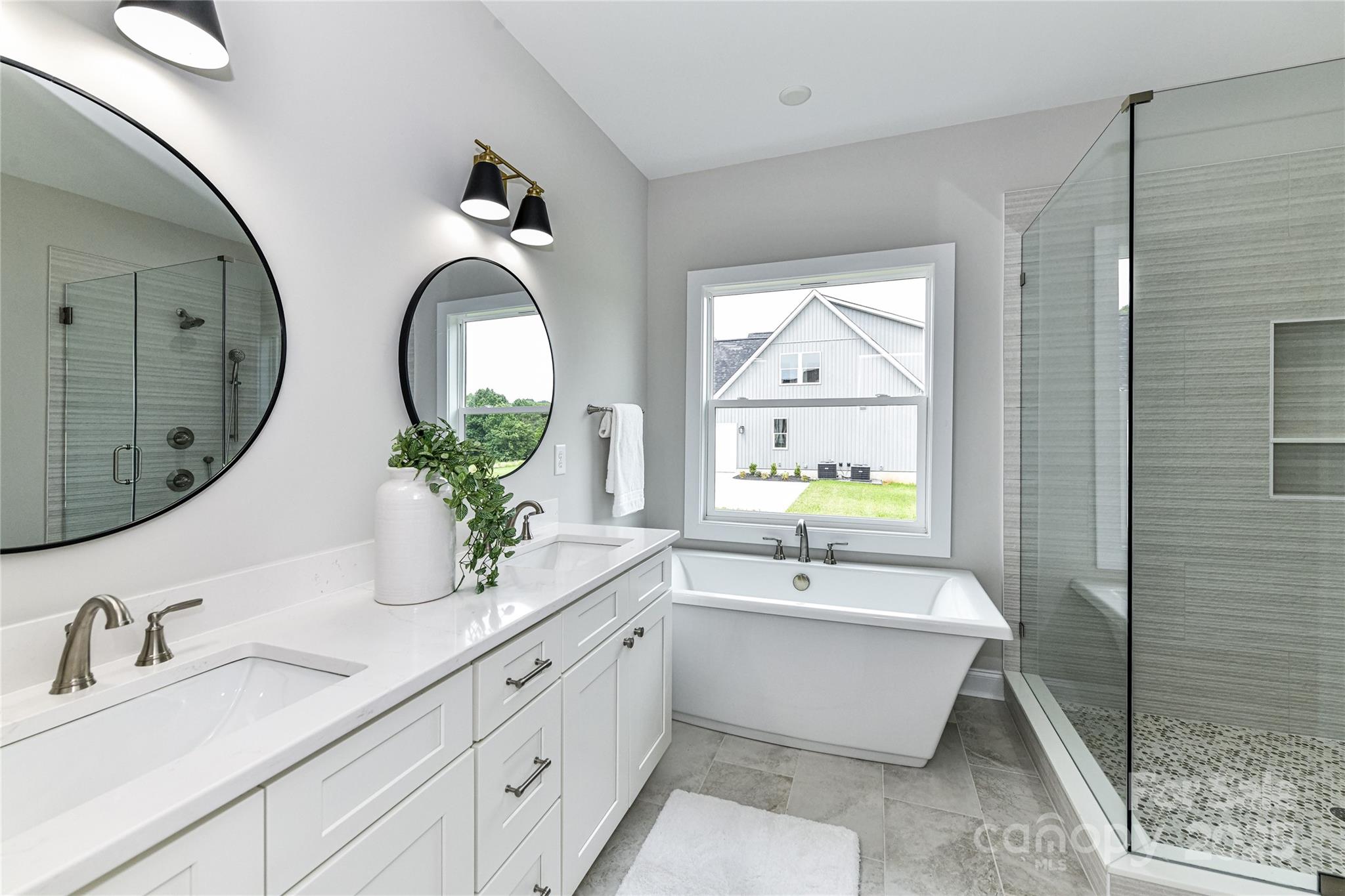 181 Lone Pine Road Statesville, NC 28625 - Photo 22 of 42 a bathroom with double vanity sinks and a bathtub