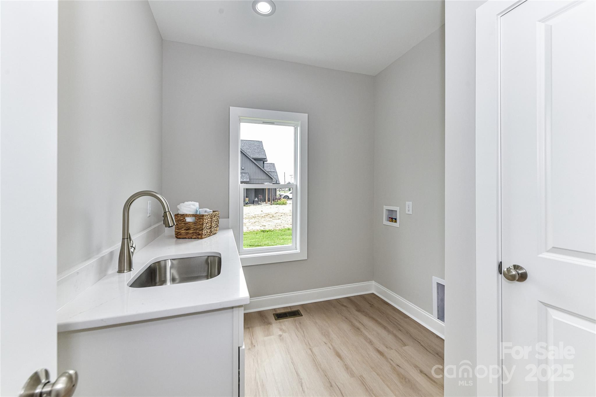 181 Lone Pine Road Statesville, NC 28625 - Photo 24 of 42 a kitchen with a sink and a wooden floor