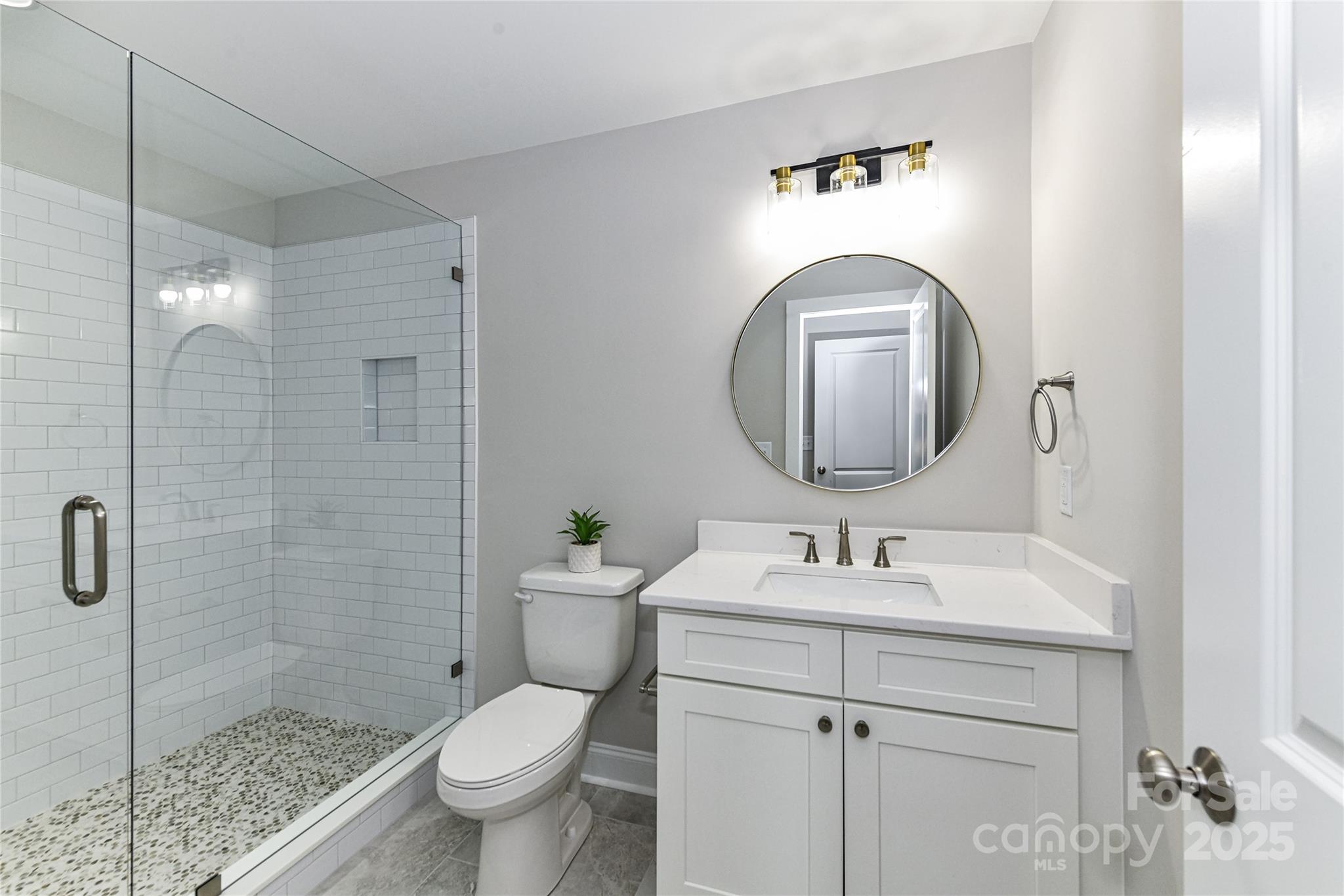 181 Lone Pine Road Statesville, NC 28625 - Photo 28 of 42 a bathroom with a toilet sink and mirror