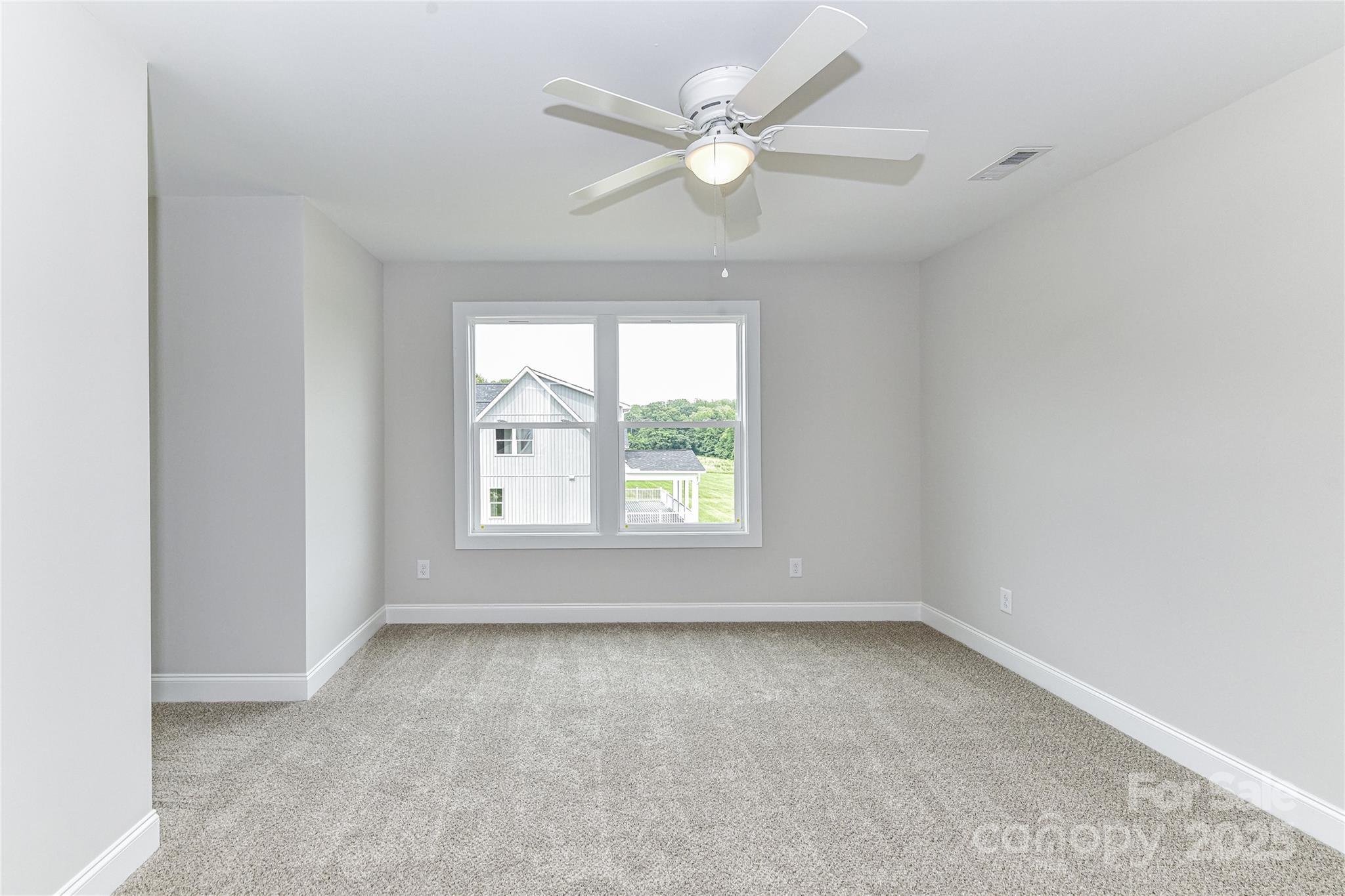 181 Lone Pine Road Statesville, NC 28625 - Photo 29 of 42 an empty room with windows and ceiling fan