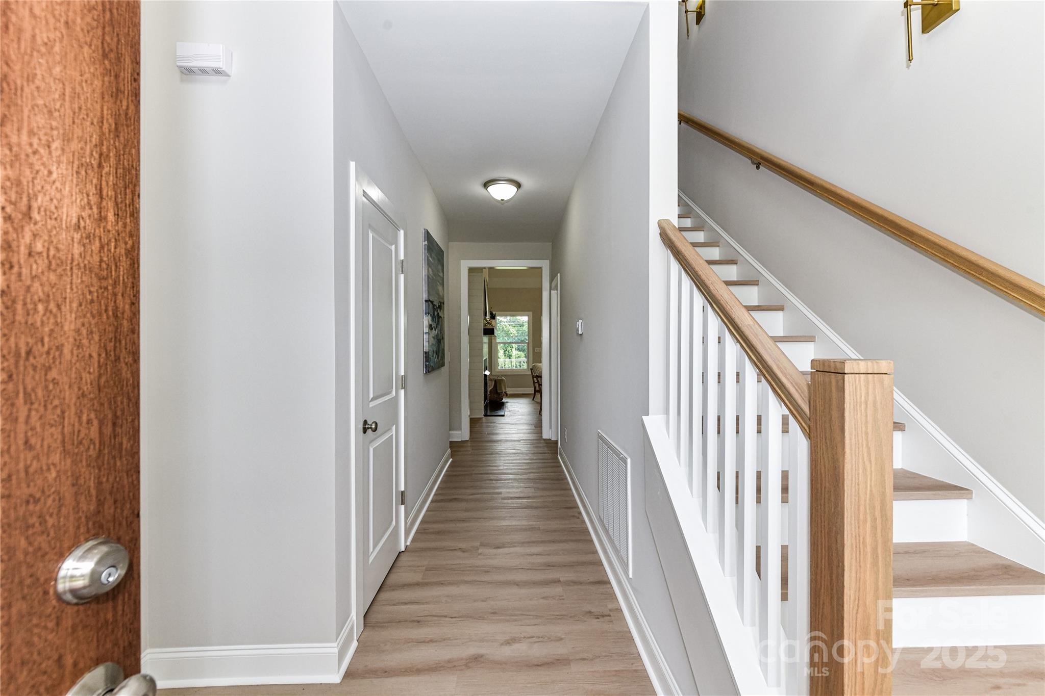 181 Lone Pine Road Statesville, NC 28625 - Photo 6 of 42 a view of a hallway with wooden floor and stairs