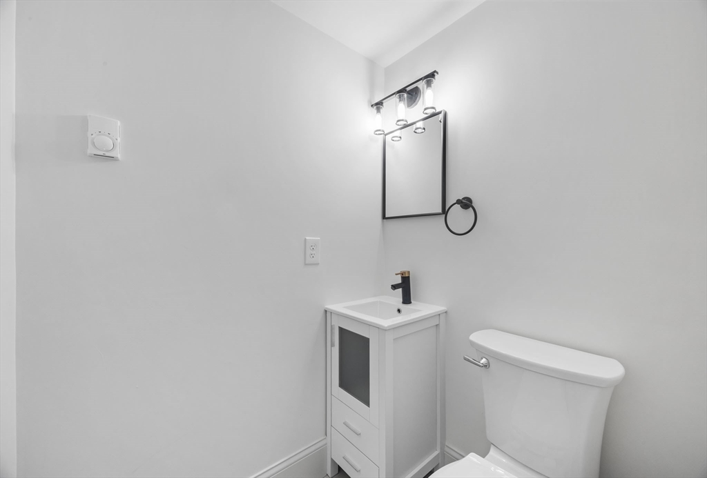 9 Swan Street, Unit 3 Beverly, MA 01915 - Photo 10 of 36 a bathroom with a sink toilet and mirror