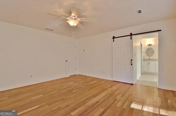 a view of an empty room with wooden floor