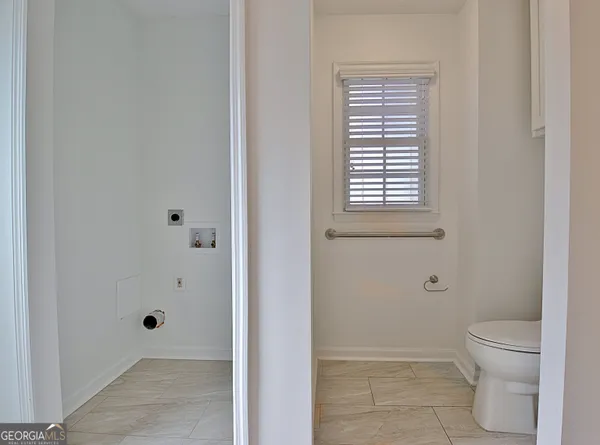 a bathroom with a granite countertop toilet a sink and shower