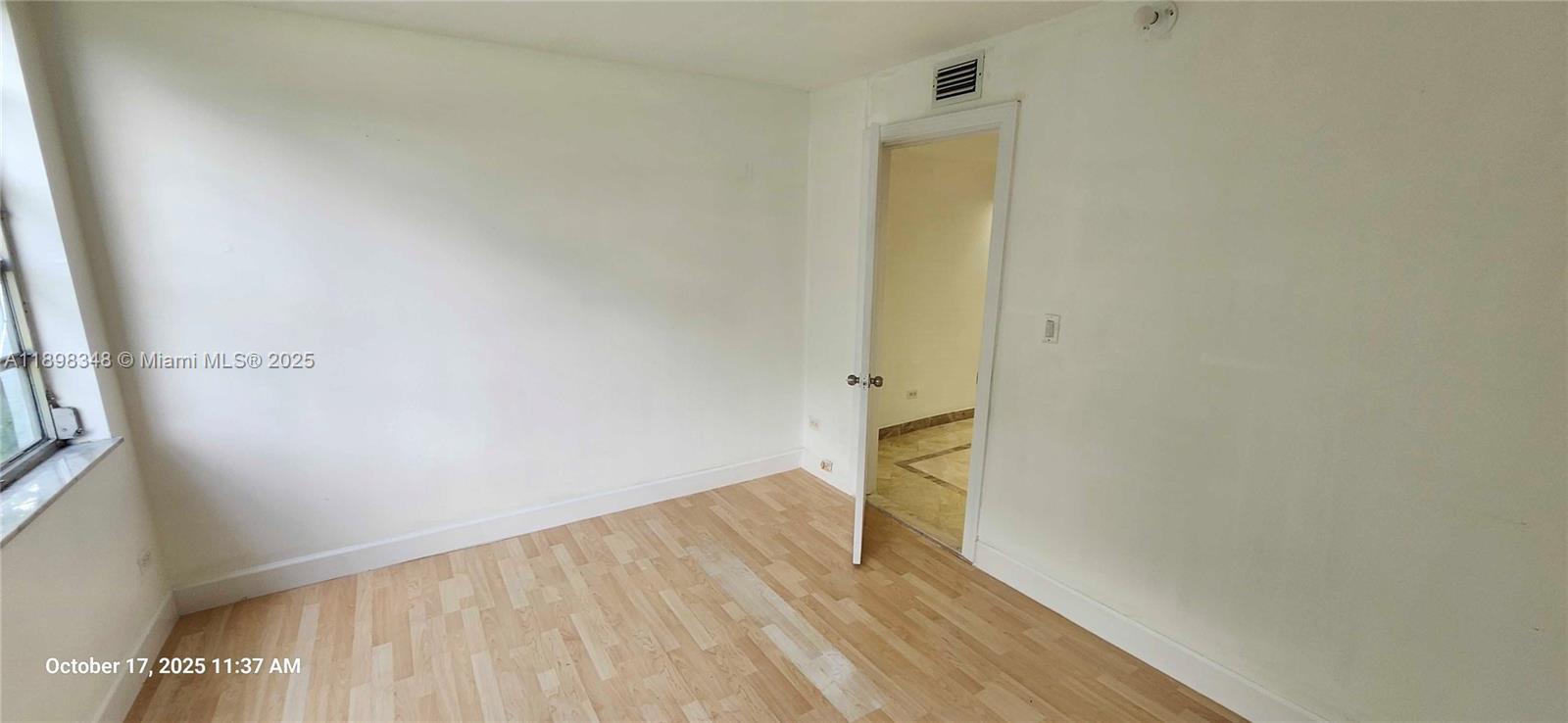 443 Northeast 195th Street, Unit 238 Miami, FL 33179 - Photo 13 of 15 a view of empty room with wooden floor