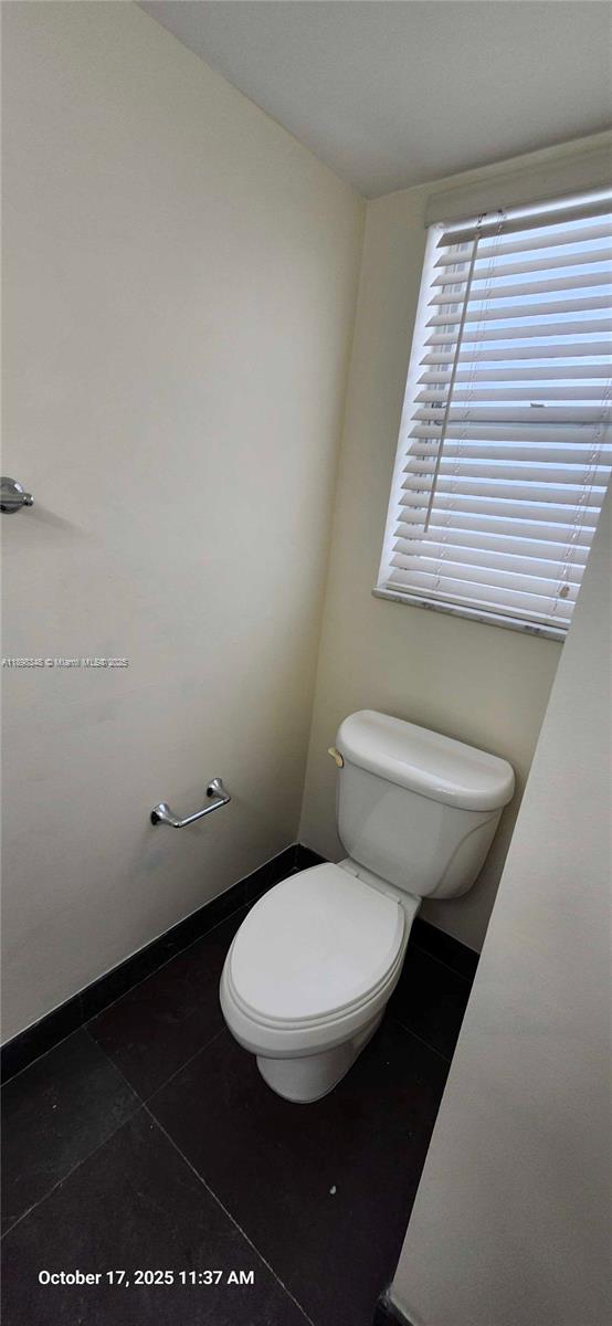 443 Northeast 195th Street, Unit 238 Miami, FL 33179 - Photo 8 of 15 a bathroom with a toilet and a window