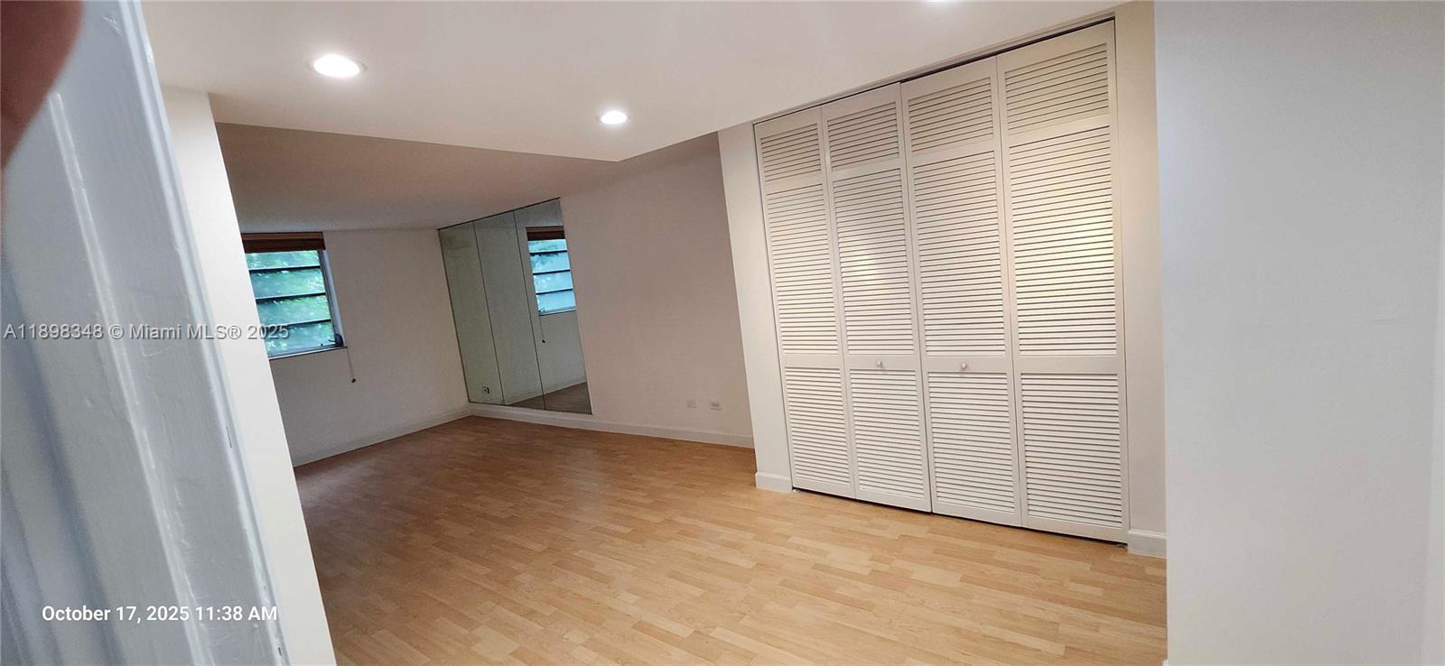 443 Northeast 195th Street, Unit 238 Miami, FL 33179 - Photo 9 of 15 an empty room with windows