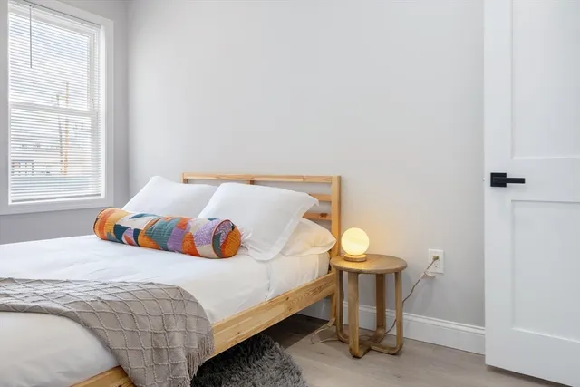 a bedroom with a bed and window