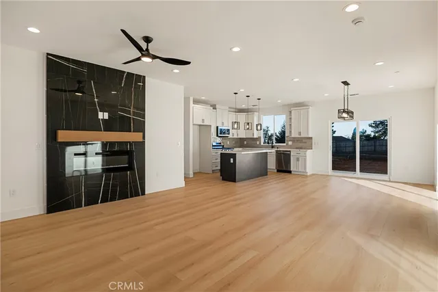 a large kitchen with stainless steel appliances kitchen island a stove a refrigerator a sink dishwasher with a dining table and chairs