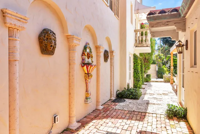 a living room with furniture a fireplace and a chandelier