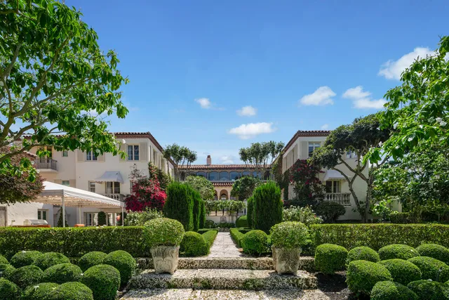 a living room with furniture a chandelier and a large window