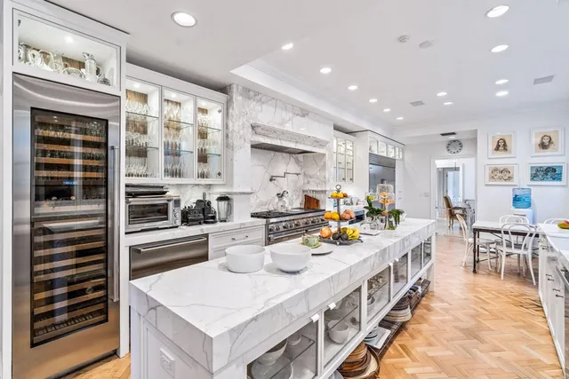 a living room with a bed and a chandelier