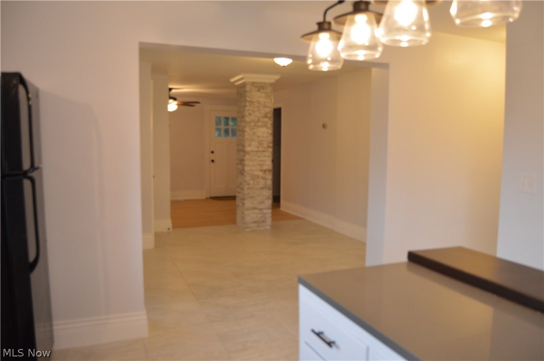 Looking through the dining room to living room in back ground from the kitchen view. To the right is the 3/4 bath with shower and the second bedroom on first level.