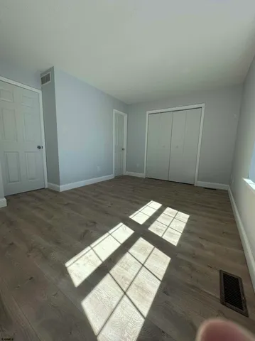 a view of a cars park in front of a building